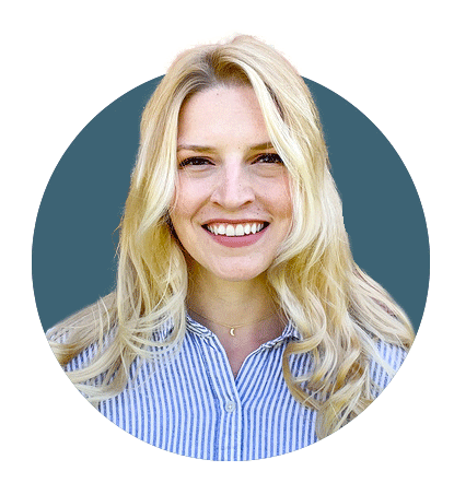 Blonde woman smiles in a blue shirt