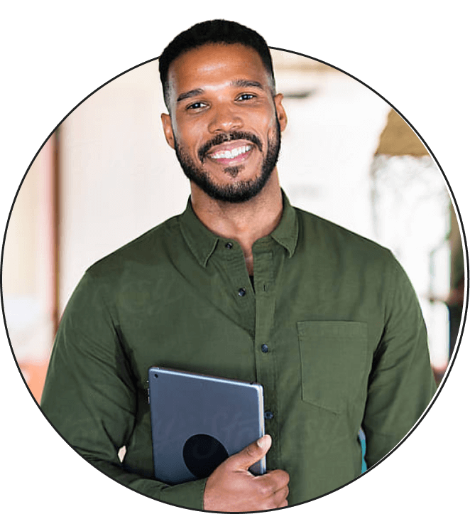 Man smiling holding laptop