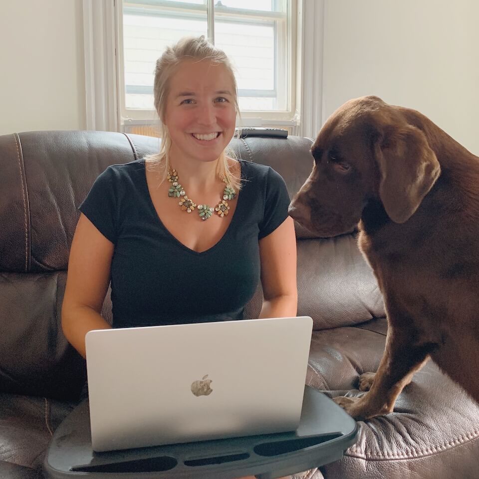 Ashley timms, digital content manager at terakeet on couch with brown dog