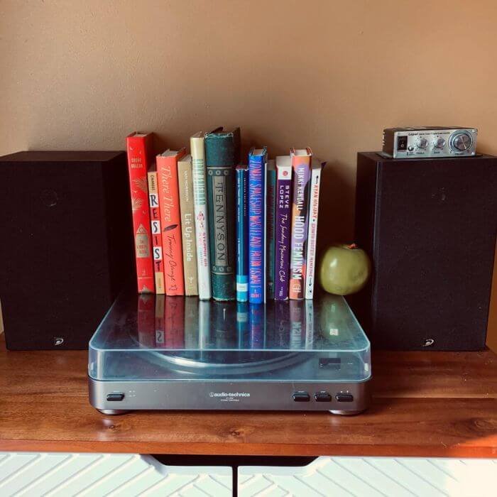 Stack of books on top of a record player