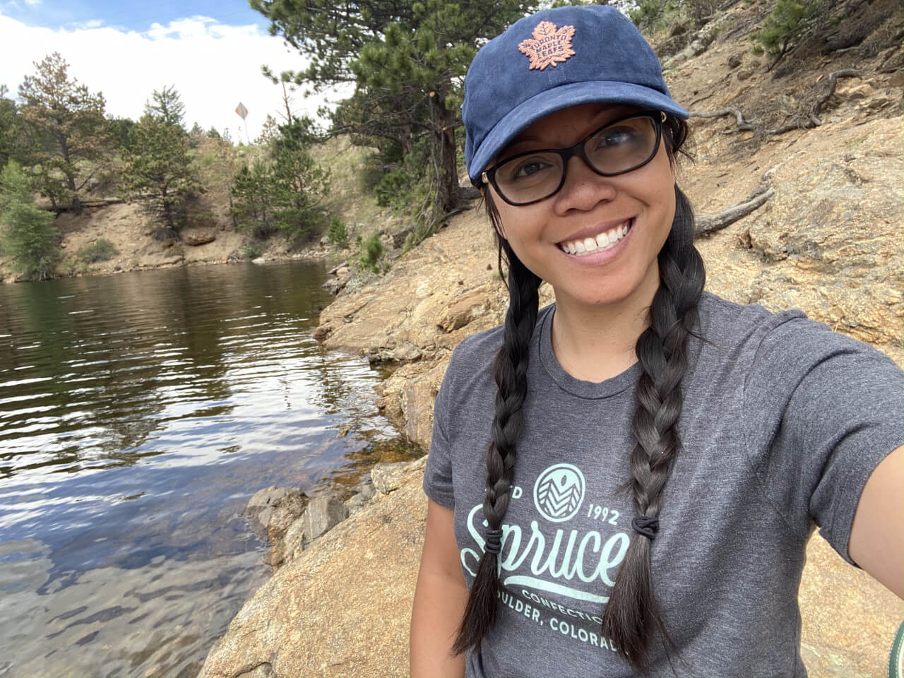 Norina Jones smiles in front of a beautiful lake