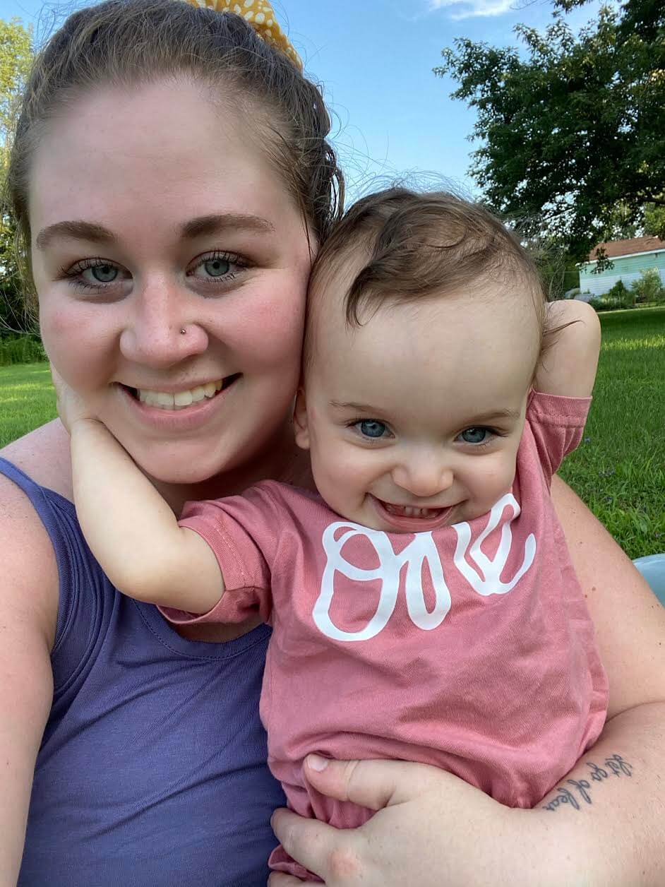 Emily and her daughter, Penelope, share a warm hug outside!