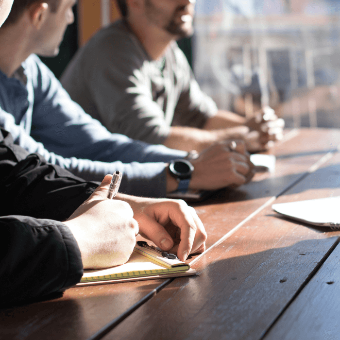 Employees sitting around a table hosting an interview