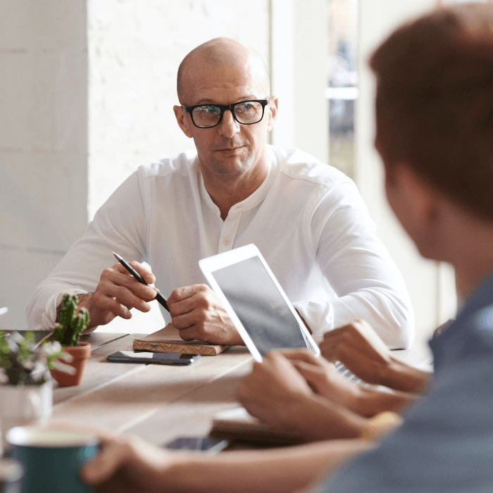 Two men lead an interview at a table