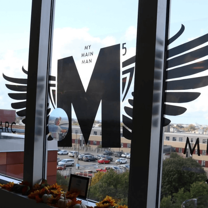 The Marc Murray Award logo sits on an office window