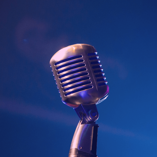 old-fashioned microphone against a blue background.