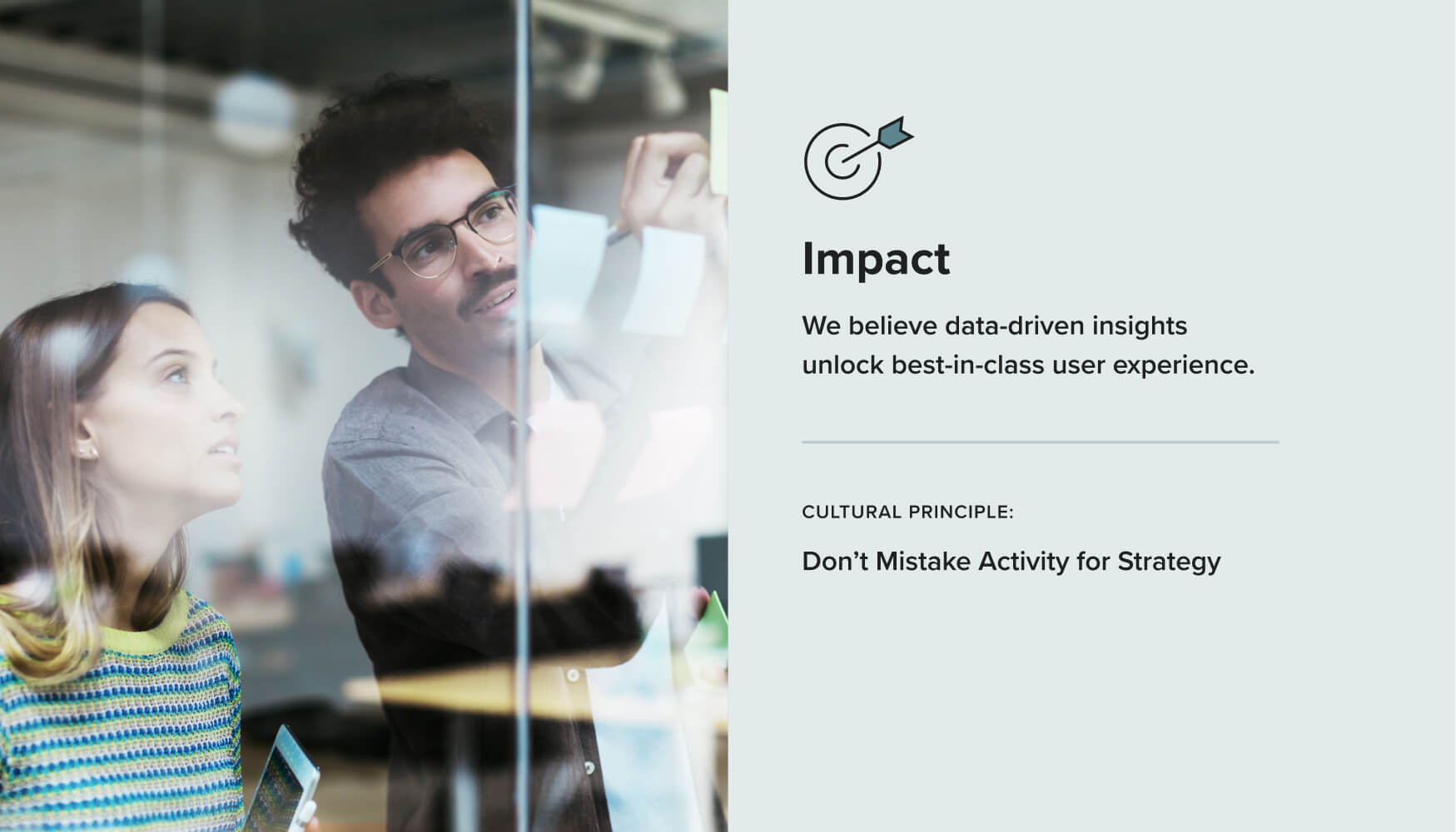 Two professionals write on a sticky note on a window beside a graphic that details Terakeet's Impact value and accompanying cultural principle.