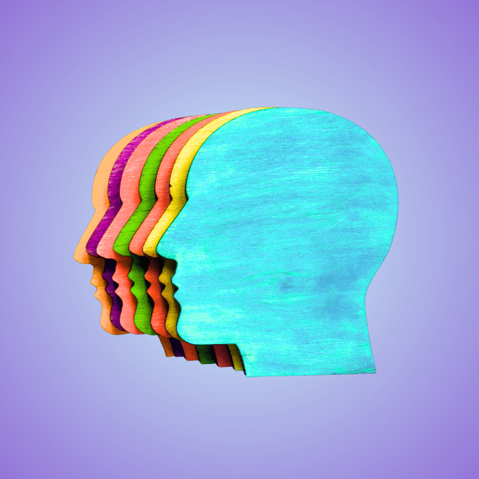 A graphical representation of several multicolored faces in profile
