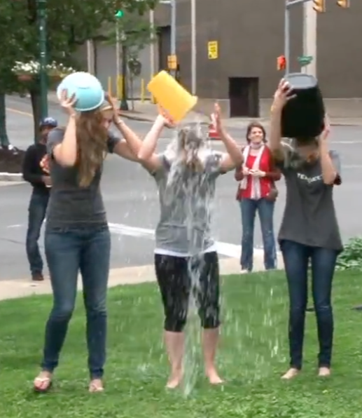 Terakeet employees pour buckets of water on their heads during the ice bucket challenge to raise awareness for ALS.