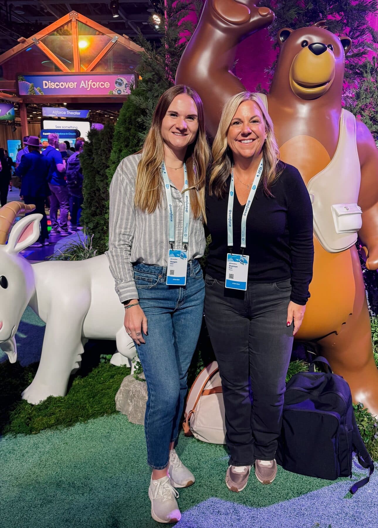 Two women pose for a photo at a conference