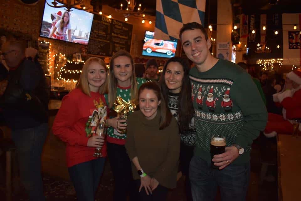 A group of Terakeet employees smile in ugly Christmas sweaters