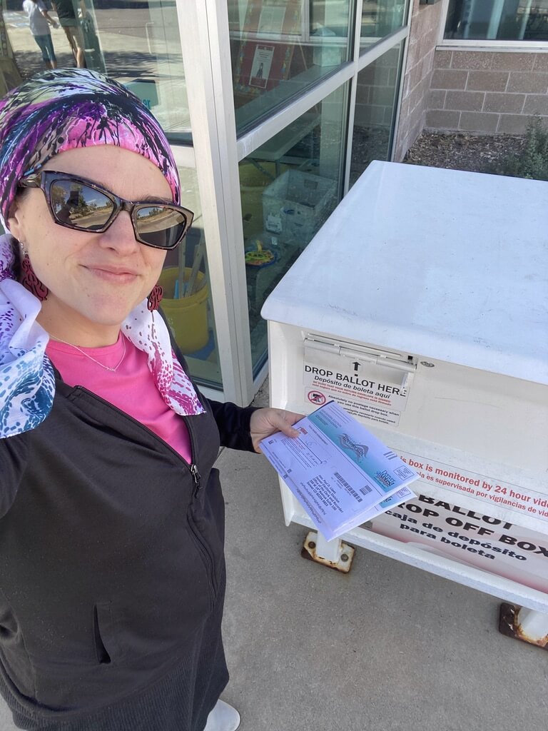 Digital Content Manager Chaviva Gordon-Bennett inserts her ballot into the mailbox.