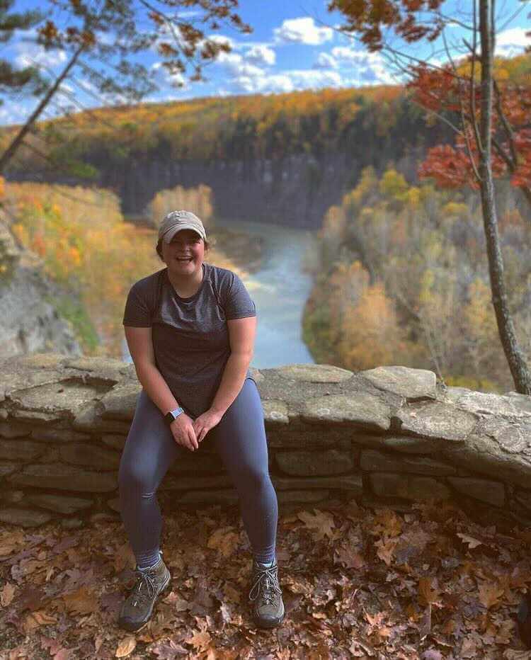 Bridget Rooney smiling in front of a gorgeous vista in upstate new york